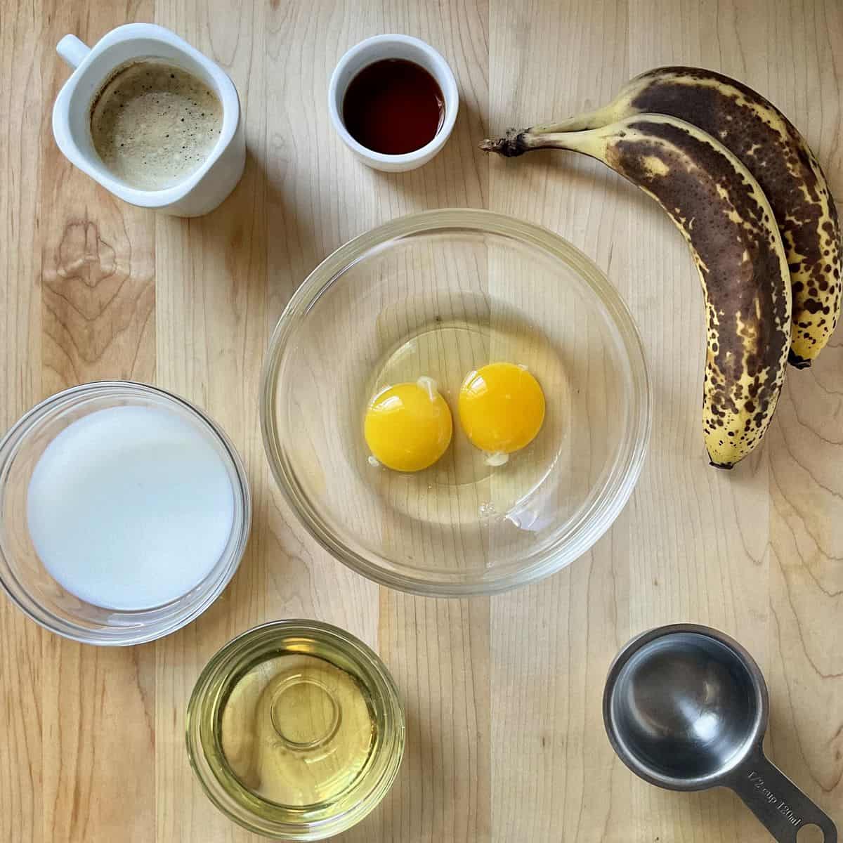 The wet and dry ingredients to make banana cake in a bowl.