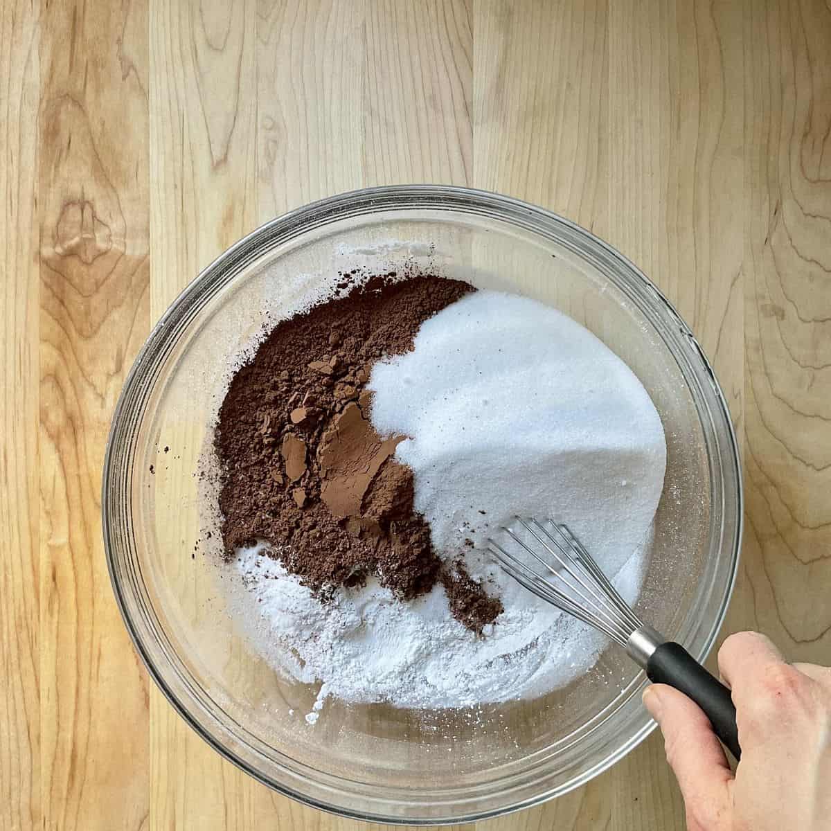 The dry ingredients to make chocolate cake in a mixing bowl.