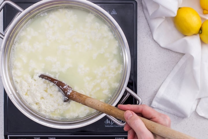 Once the lemon juice added to the milk, the ricotta curds are slowly beginning to form.