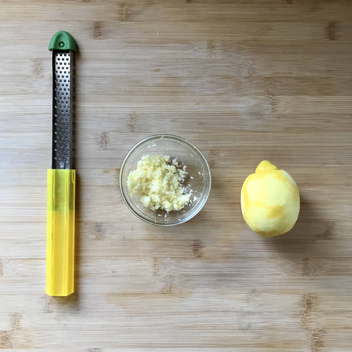Lemon sugar in a bowl on a wooden board. 