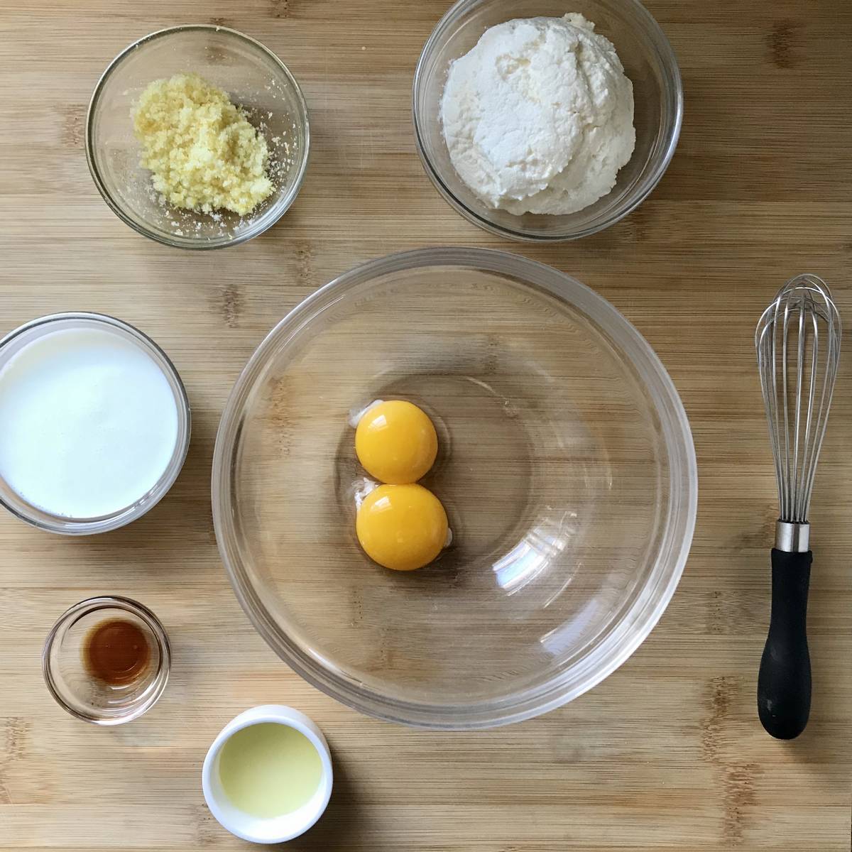 The wet ingredients used to make pancakes on a wooden board.