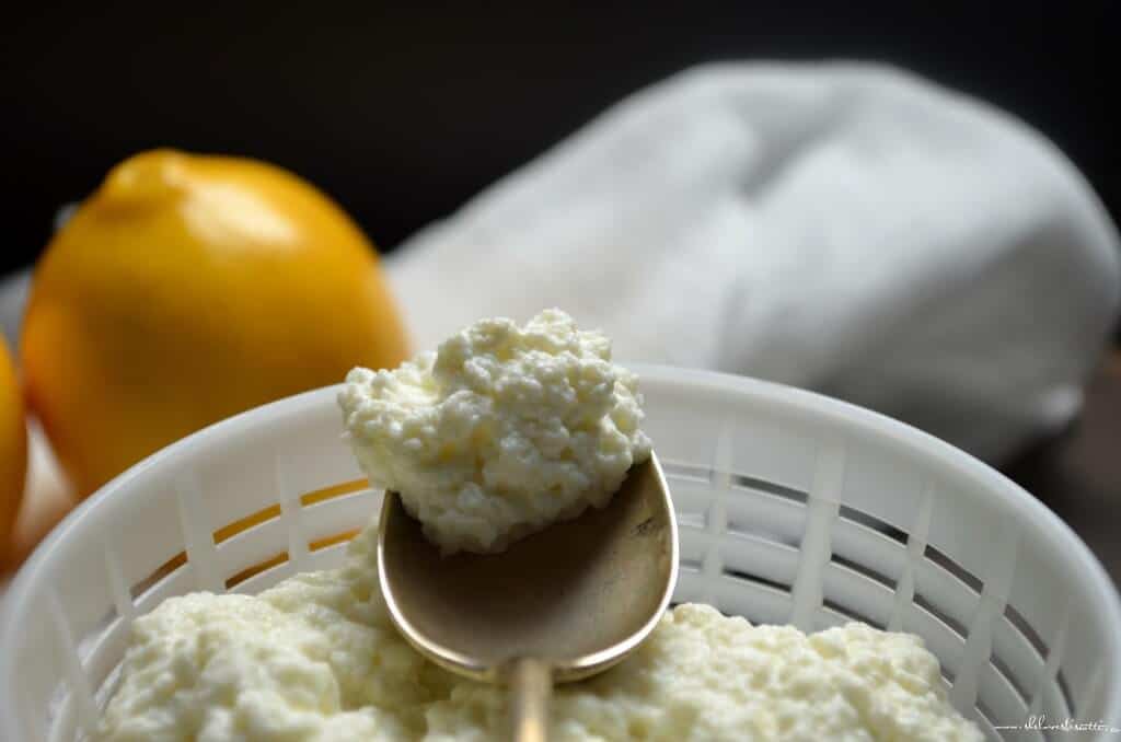 A close up shot of the creamy texture of Homemade Ricotta Cheese.
