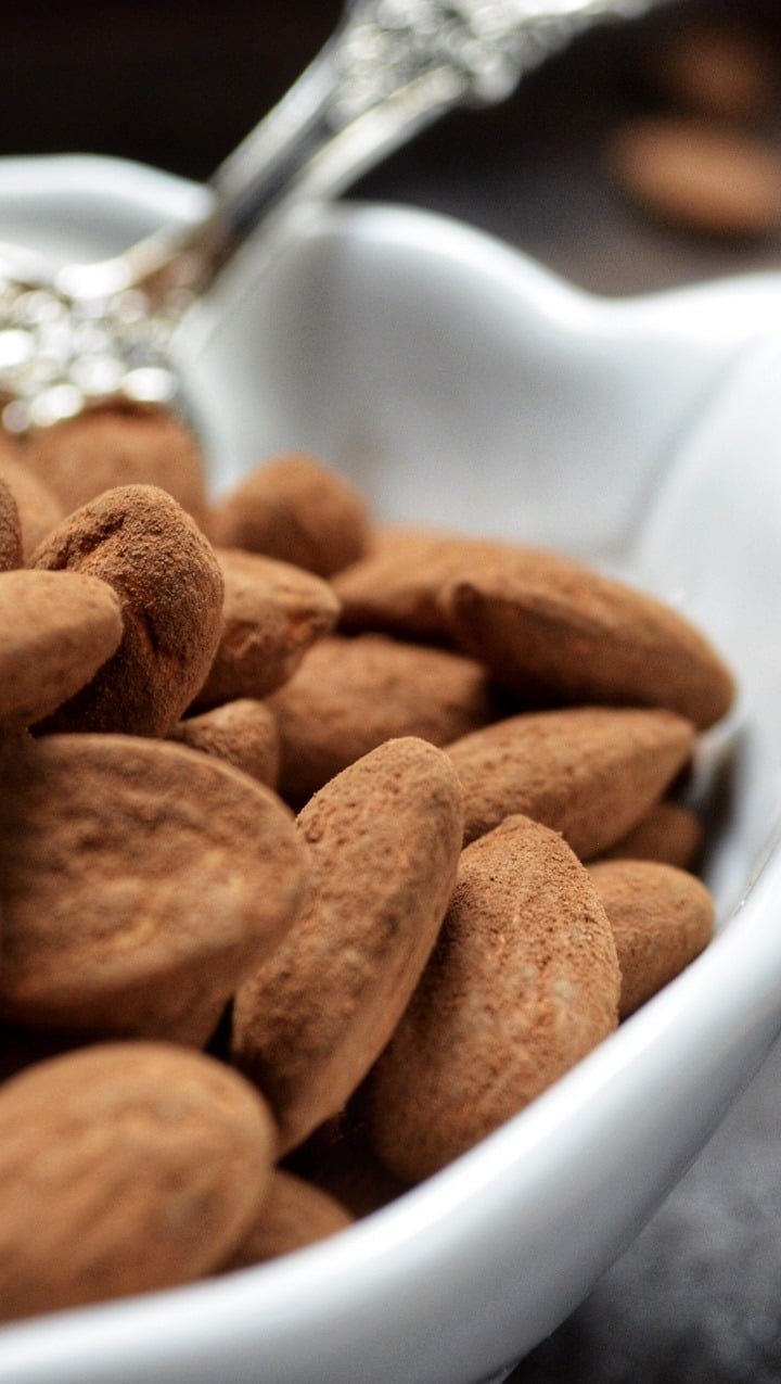 Cocoa almonds in a white bowl.