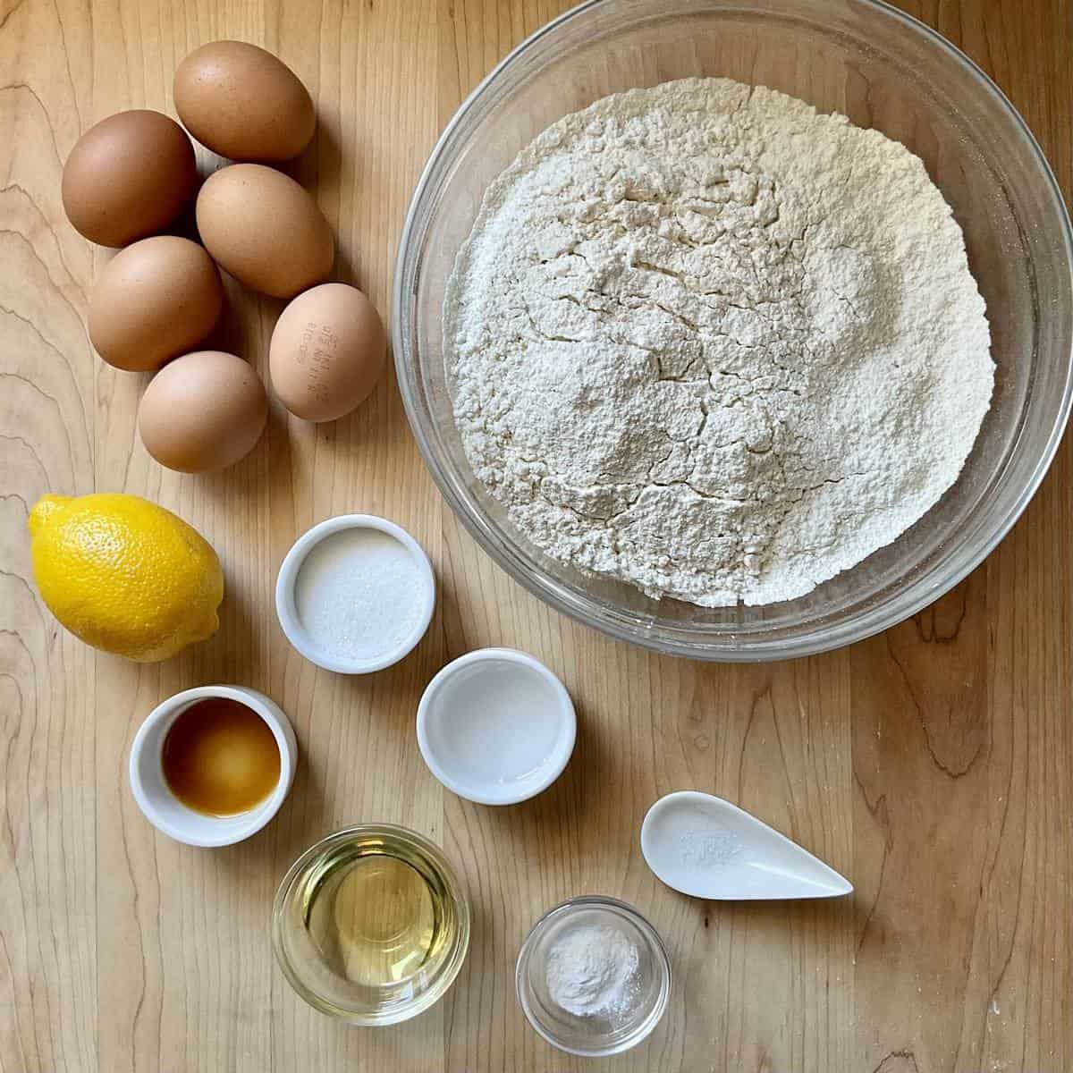 Ingredients to make egg taralli on a wooden board.