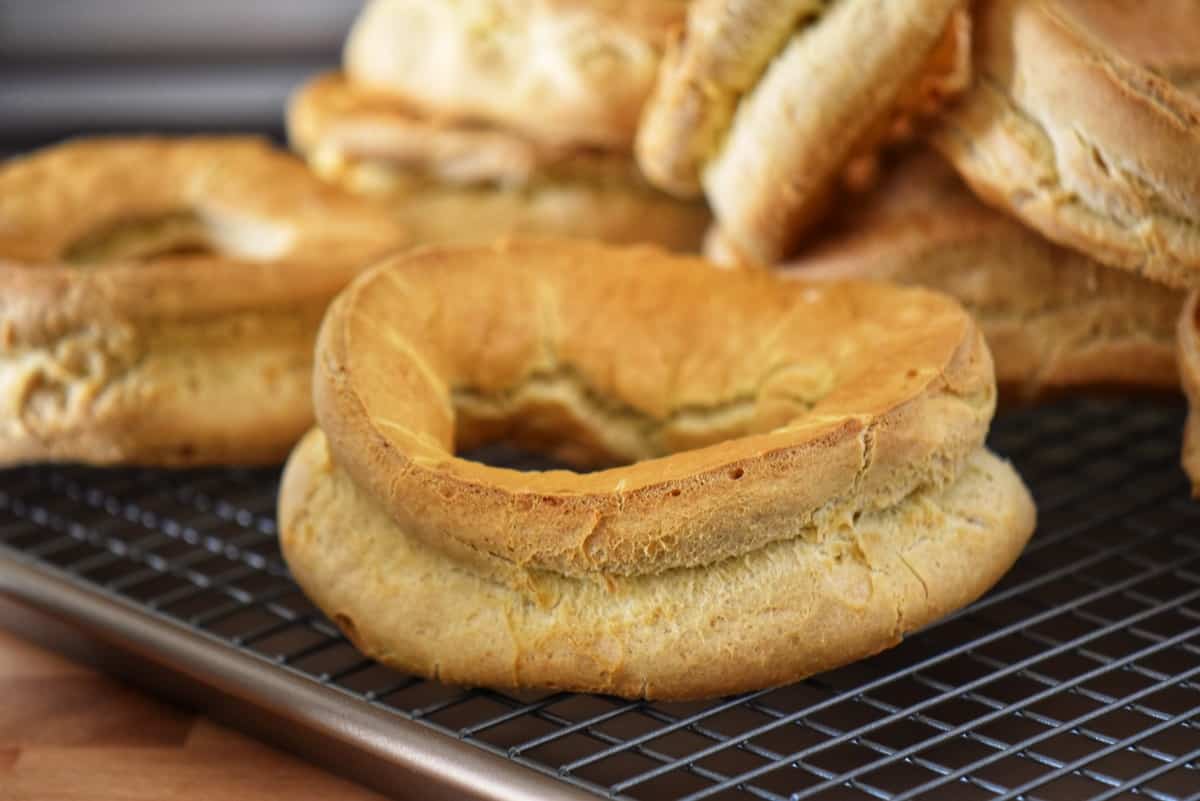 Unglazed taralli cooling off on a cookie rack.