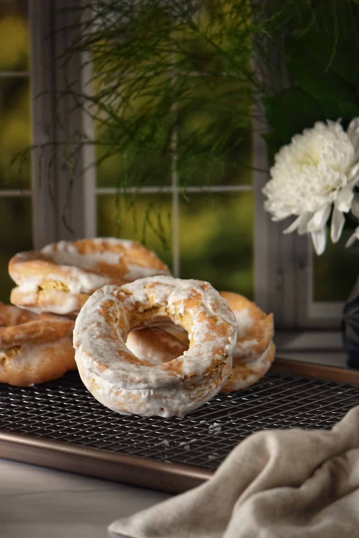 Glazed Italian taralli on a cookie rack.