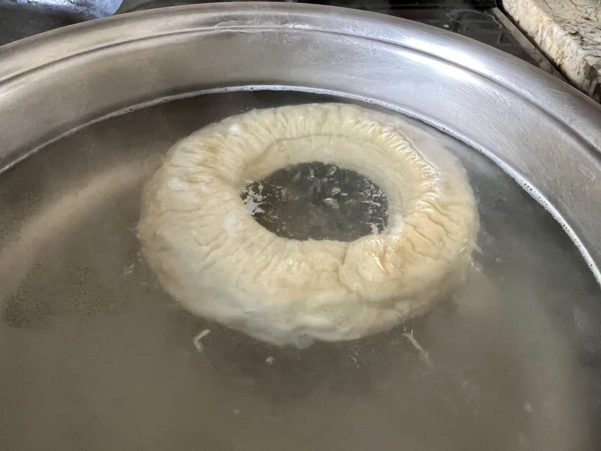 A boiled tarallo in a pot of water.