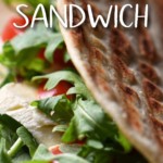 An Italian piadina sandwich filled with cheese, tomatoes, and arugula.