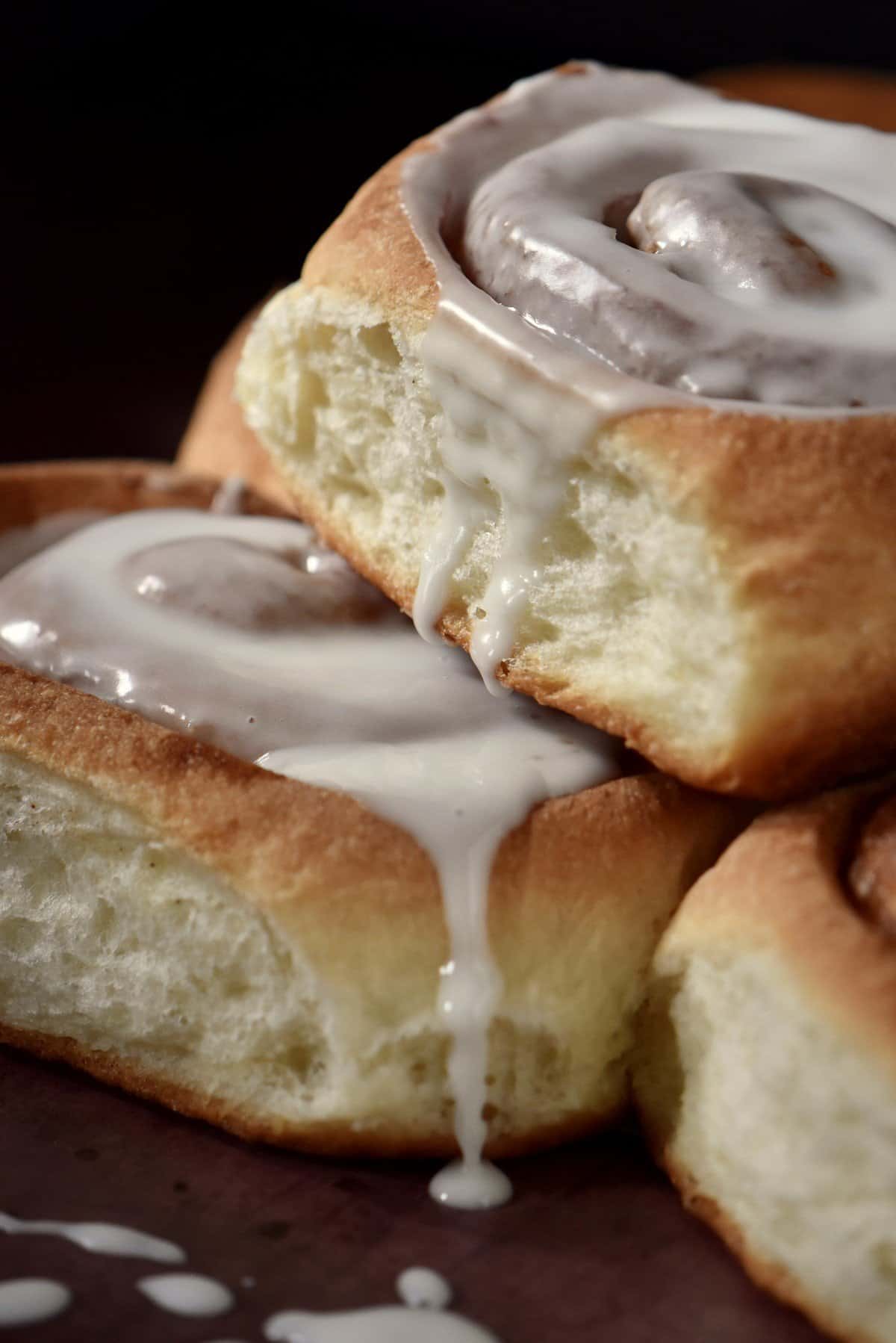 Iced cinnamon rolls on a sheet pan.