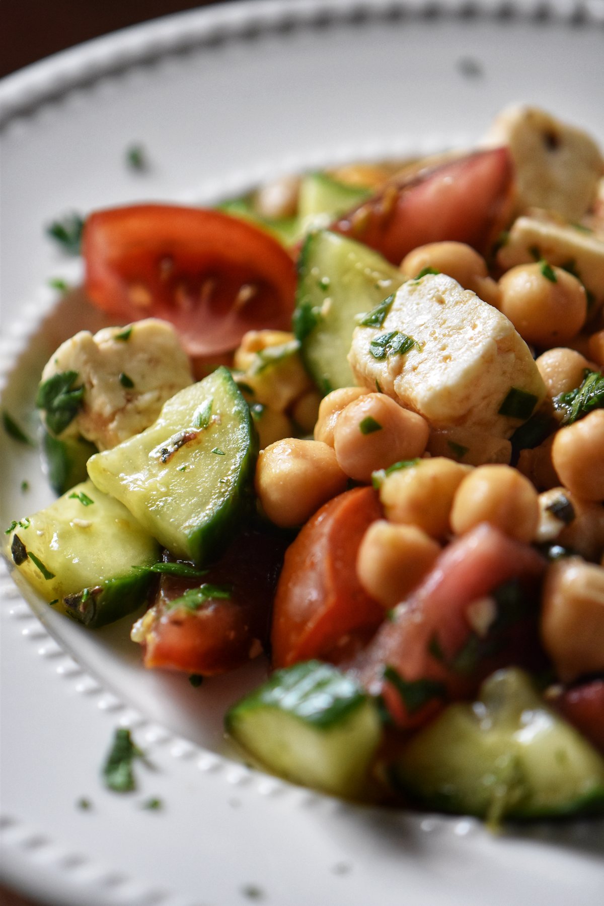 A white bowl with a generous portion of chickpea salad.