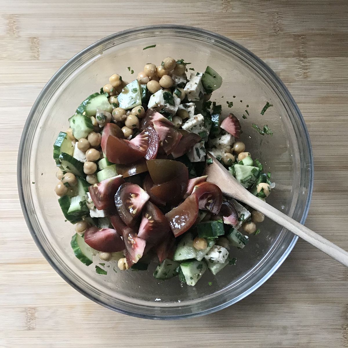 Chopped tomatoes are added to the salad.