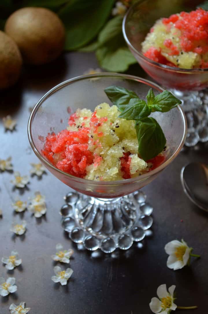 A colorful granita made with strawberries and kiwi in a glass bowl.