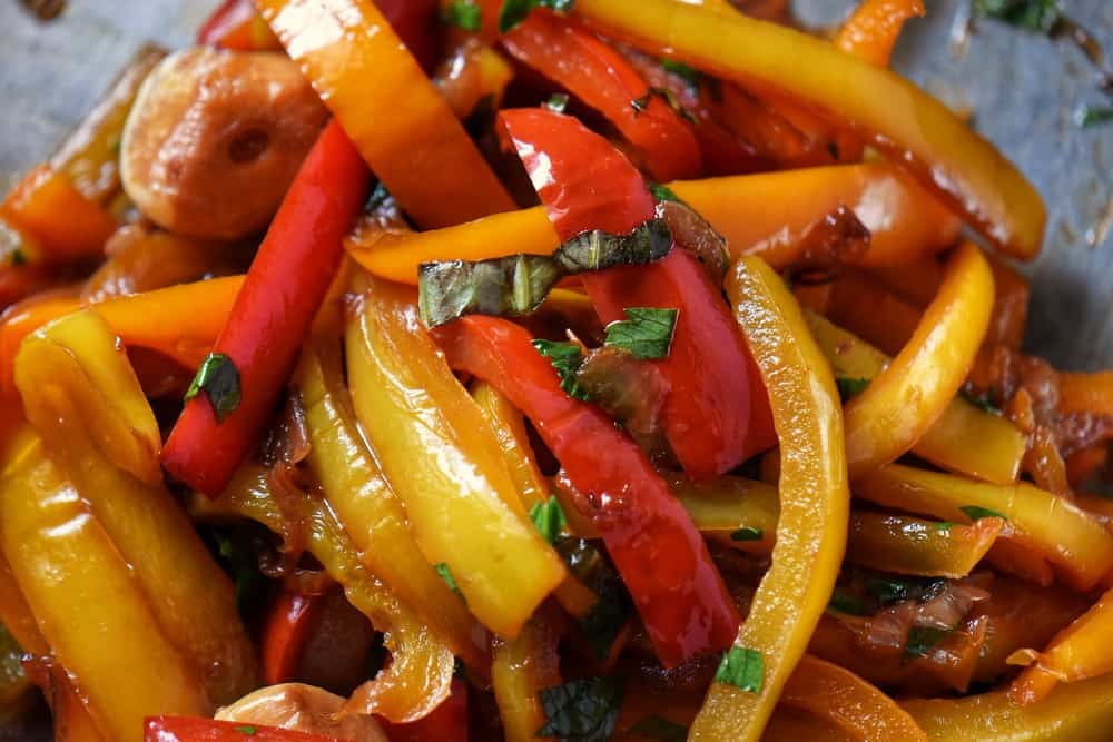 Red, orange and yellow peppers are combined to make a sweet pepper stew. 