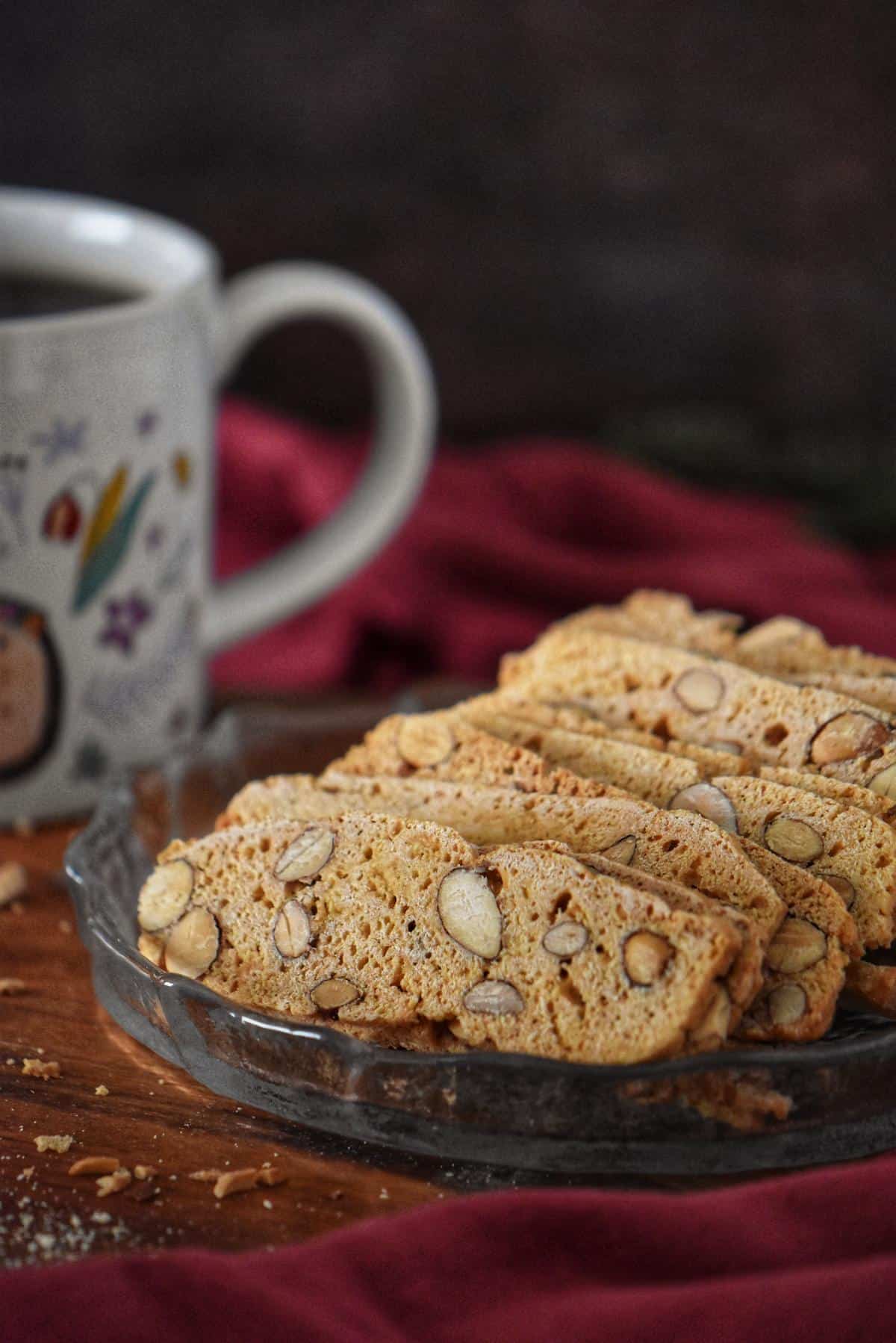 Rows of Thin Crispy Almond Biscotti di Nunzia are shown on a plaque.