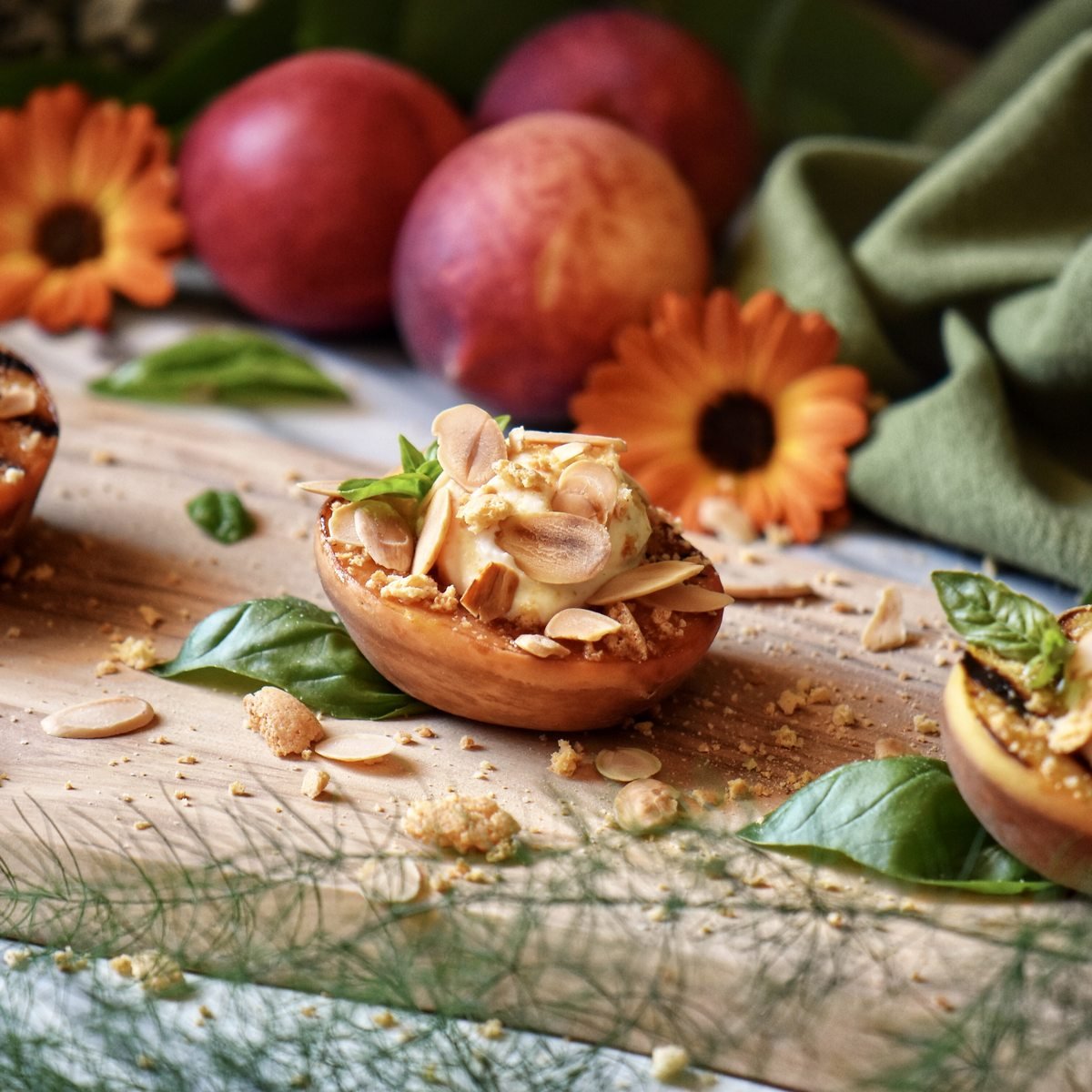 A grilled peach topped with ricotta, almonds and crushed amaretti cookies.