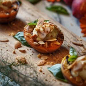 Grilled peaches garnished with ricotta, almonds and crushed amaretti cookies.