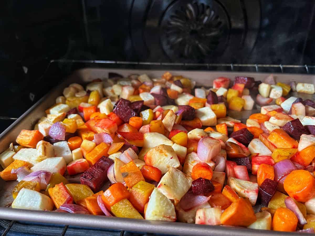 Roasted beets and root vegetables on a sheet pan.