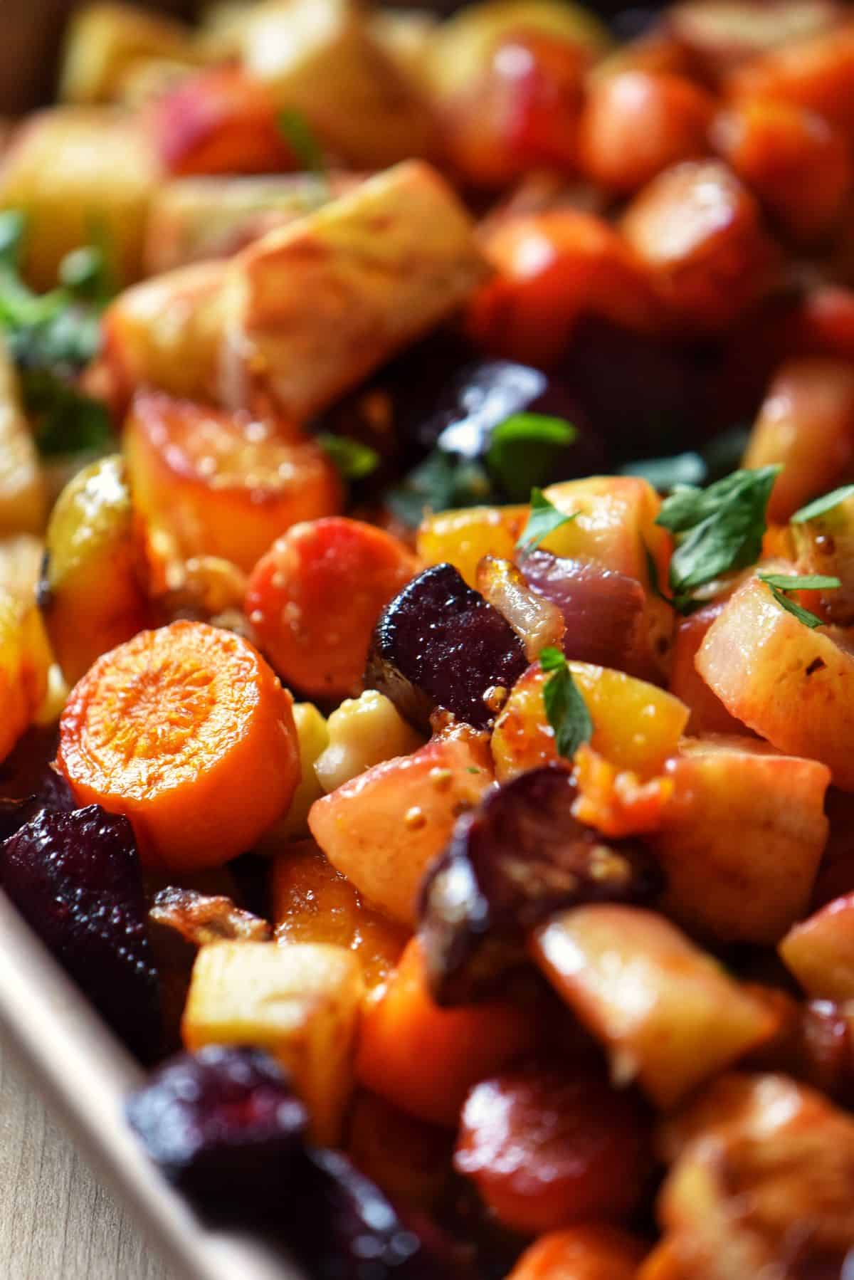 An overhead shot of roasted root vegetable medley in a round bowl.