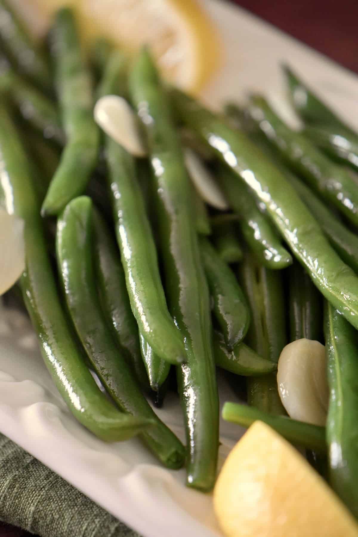 Green beans on a white plate.
