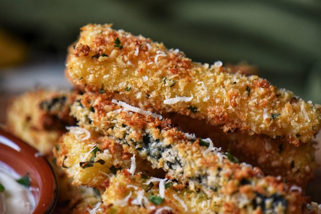 A close up shot of golden baked panko encrusted zucchini.
