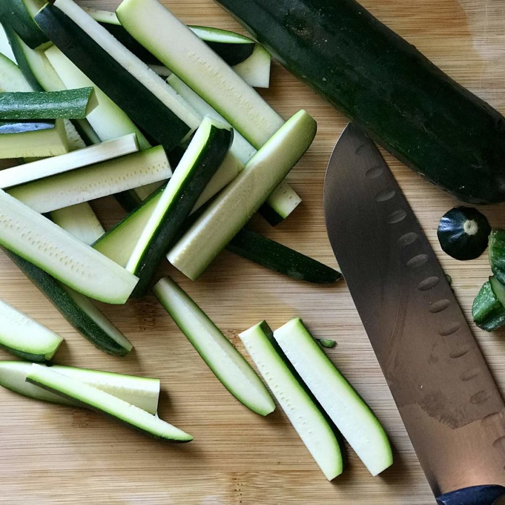 Sliced courgette on a wooden board.