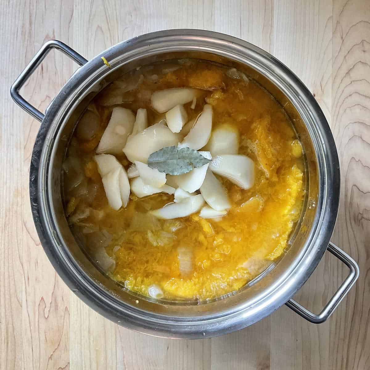 Chopped pears and roasted butternut squash in a pot.