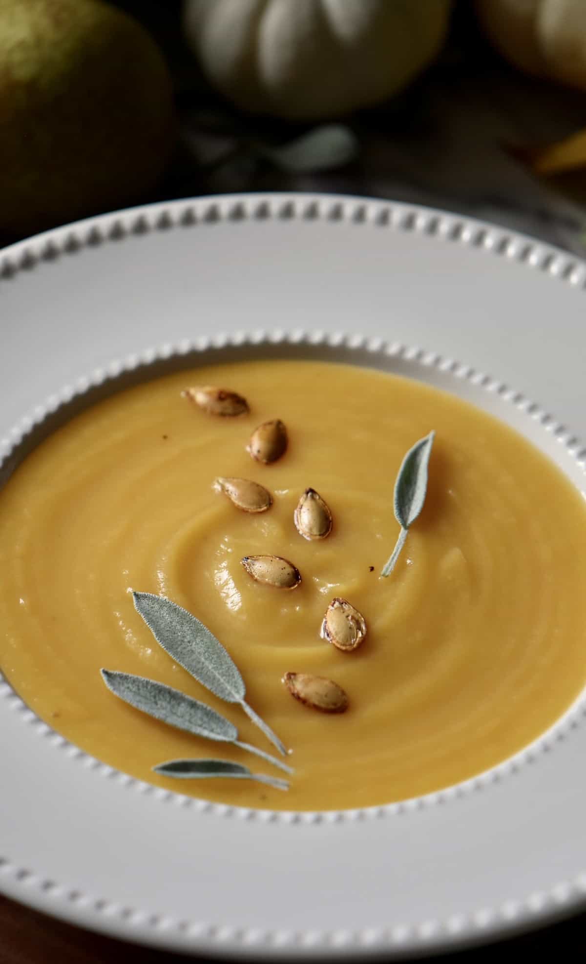 Butternut squash soup in a white soup bowl.