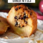 Sliced baked apple with caramelized top showing the warm, spiced oat and currant filling inside.