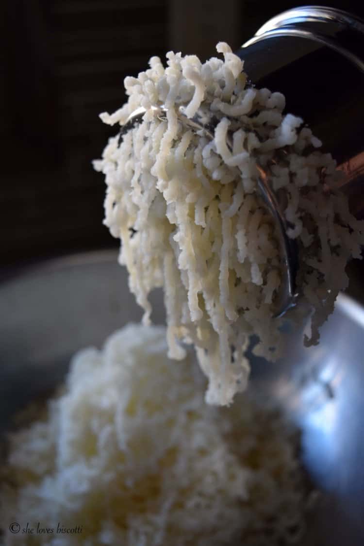 Mashed potato is passed through a potato ricer.