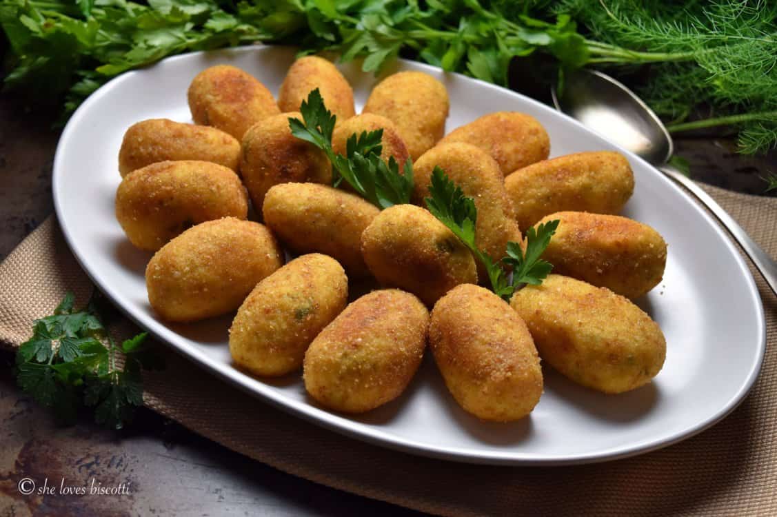 White serving platter with potato croquettes.