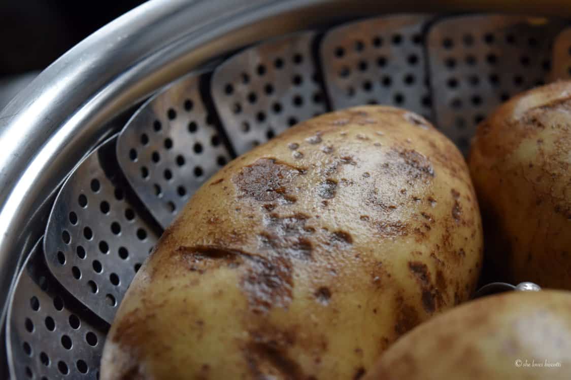 Russet potato is shown in a steamer basket.