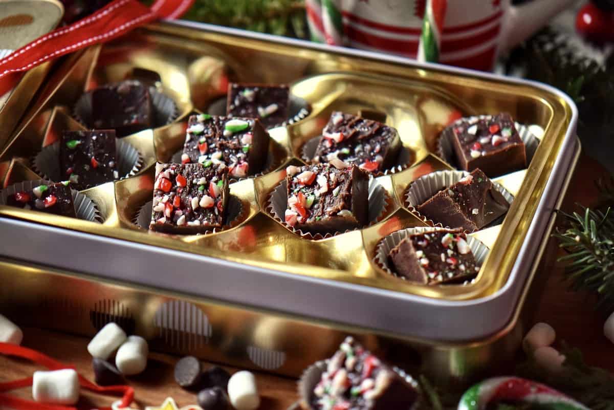 Chocolate peppermint fudge recipe in a tin candy box.