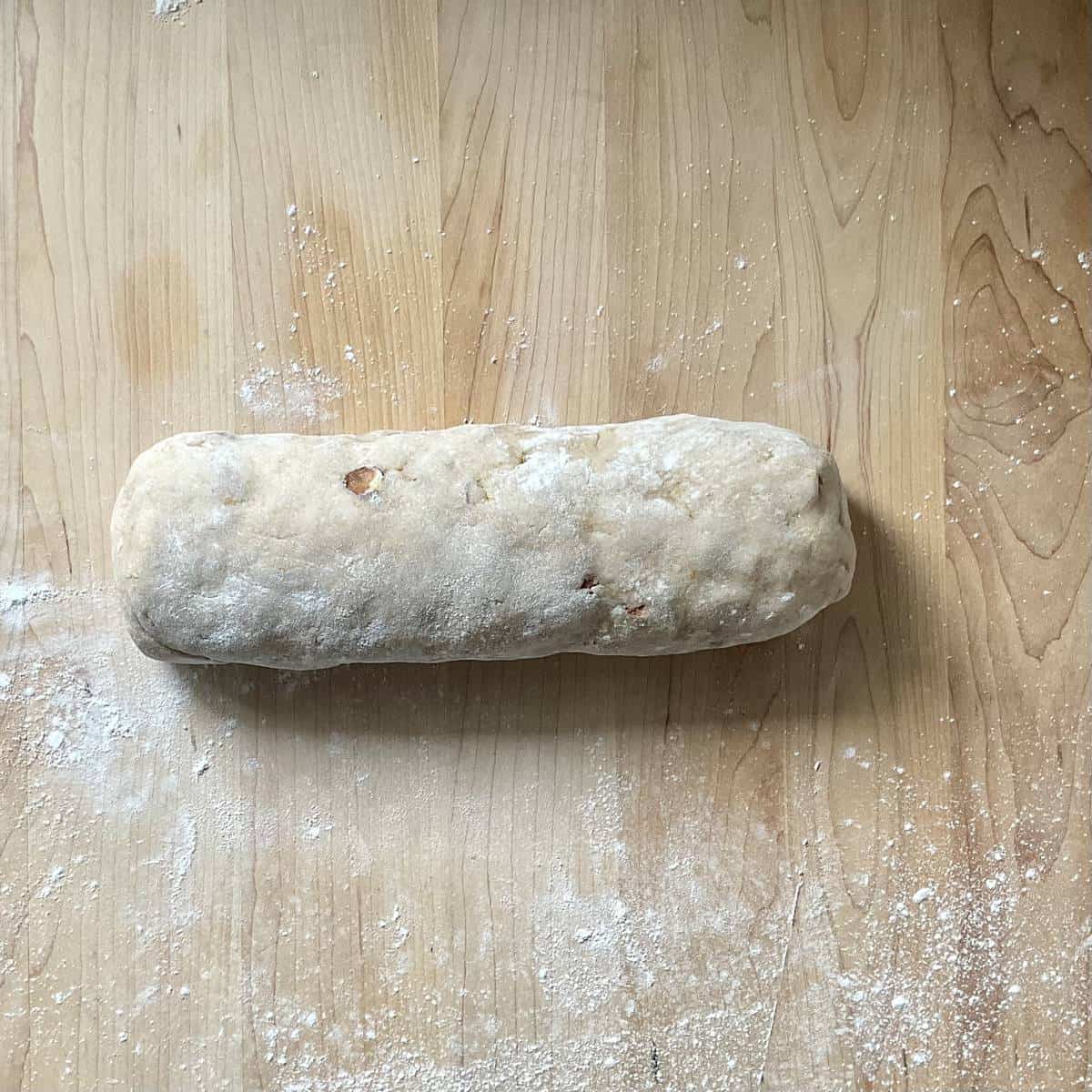 Cookie dough on a wooden board.