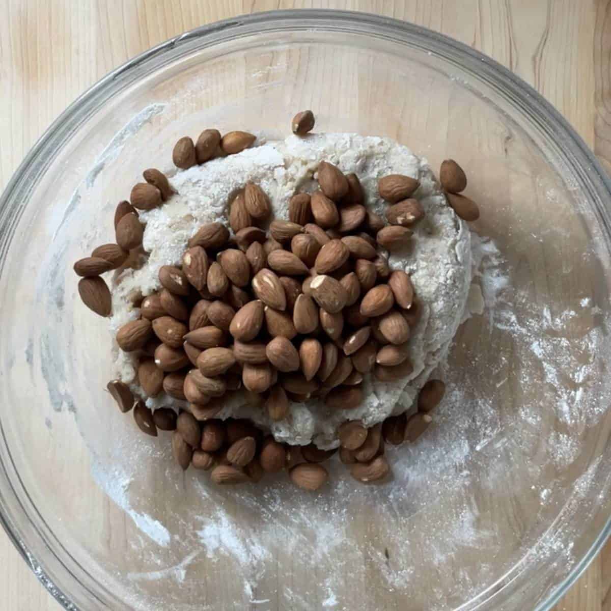 Toasted almonds are being combined with the cookie dough for Roccoco cookies.