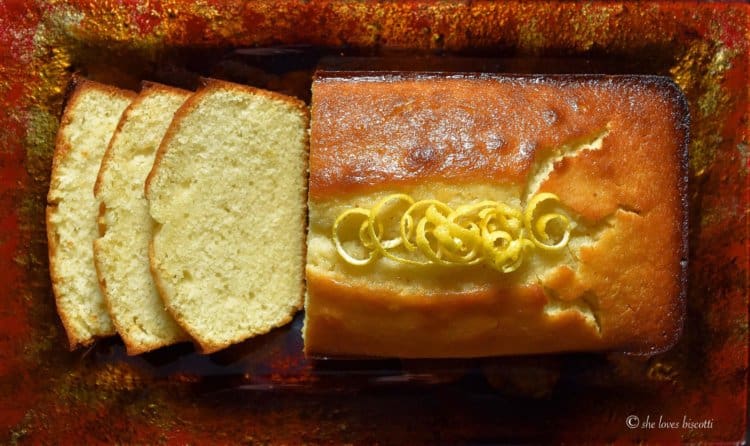 A few pieces of Extra Moist Lemony Lemon Loaf are sliced on a platter.