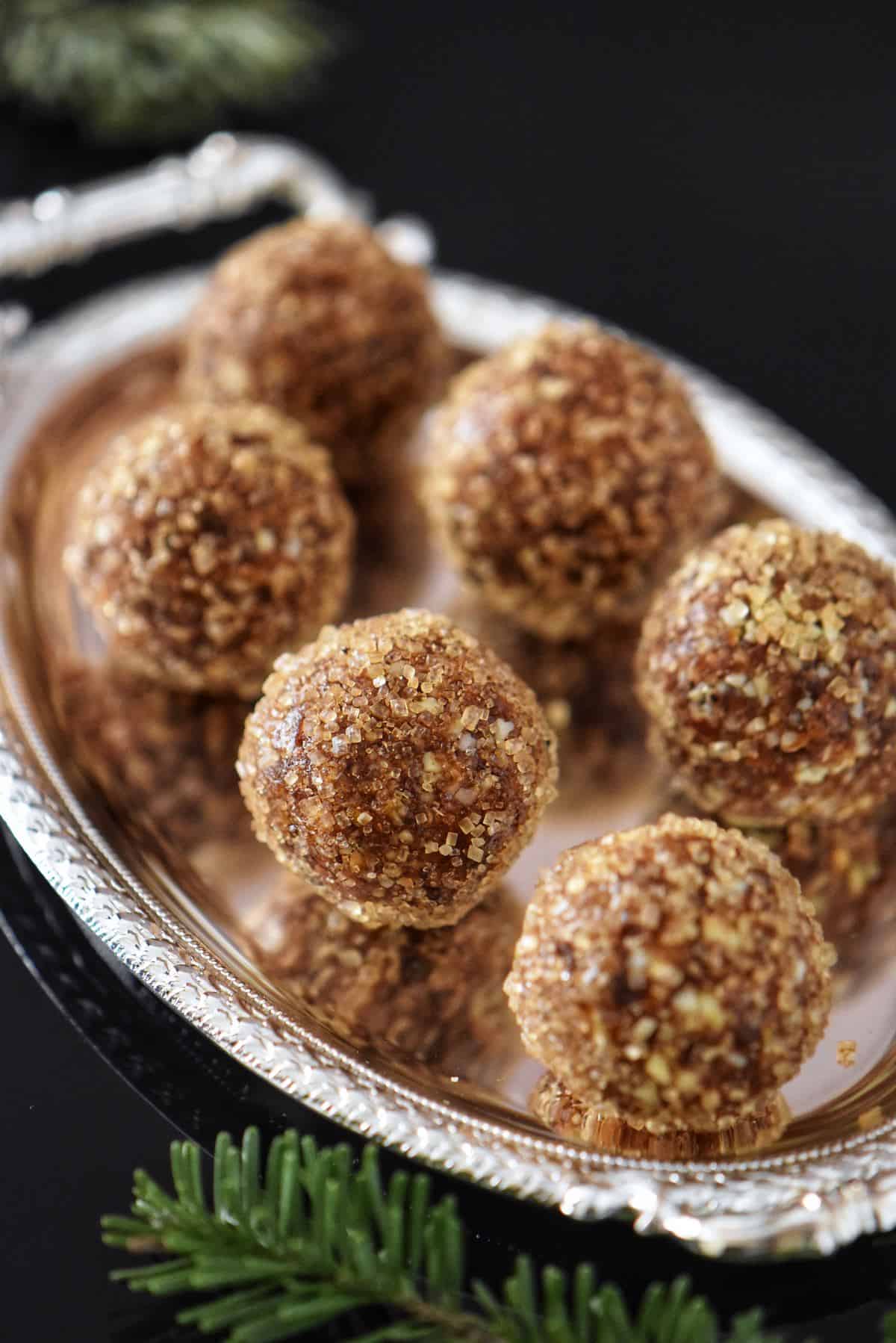 A silver tray of no bake sugar plums.