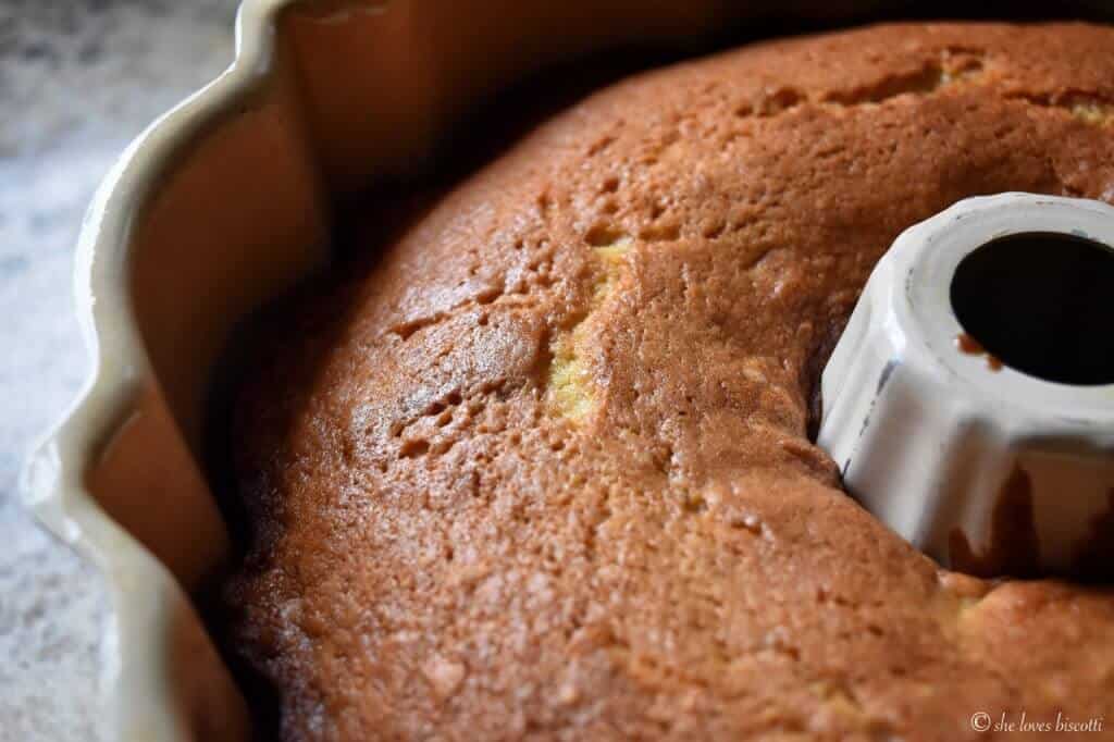 A close up of the golden brown color of the bundt cake in the pan. 