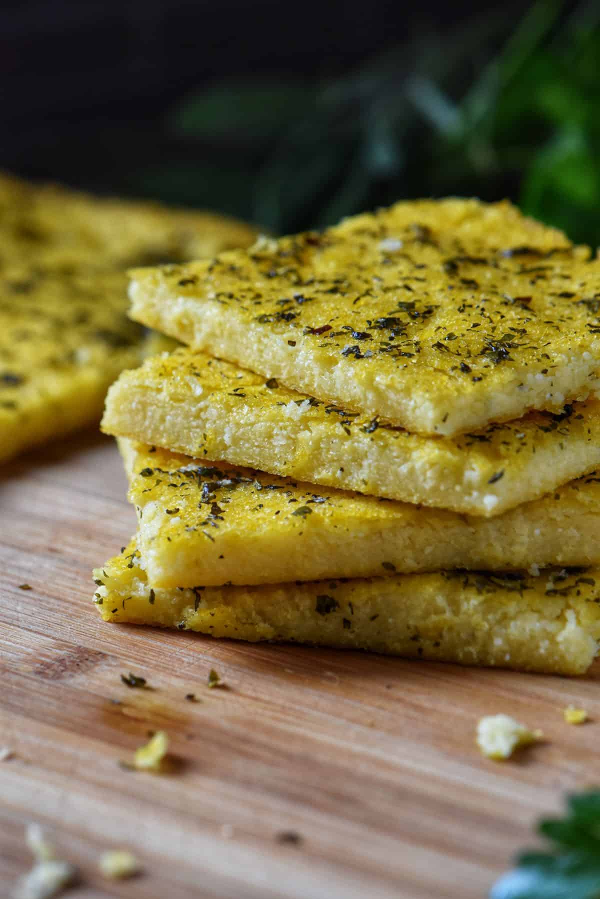 A stack of servings of polenta pizza.