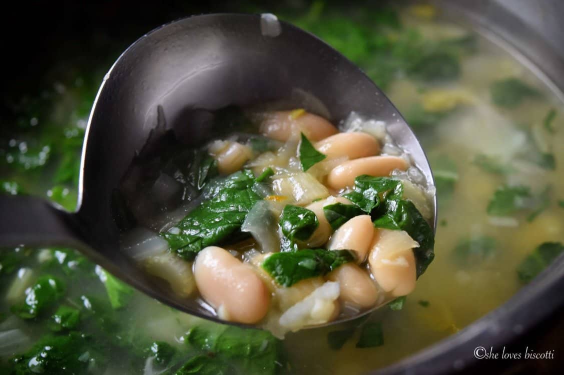 A ladle of the White Kidney Bean and Spinach Soup.