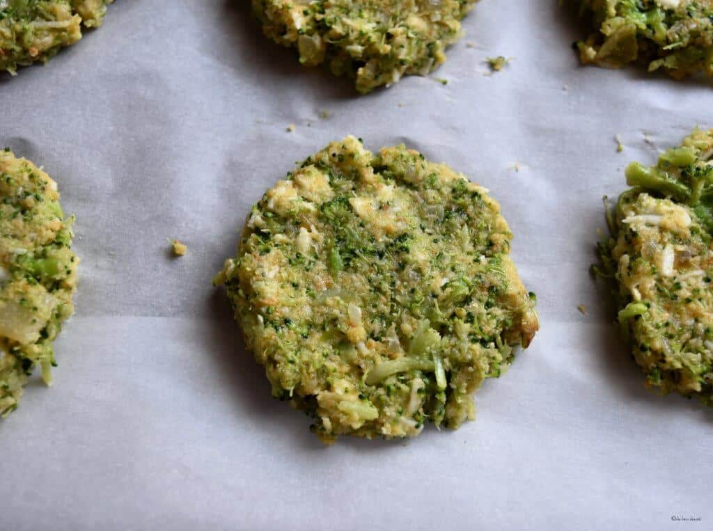 Broccoli patties on parchment paper.