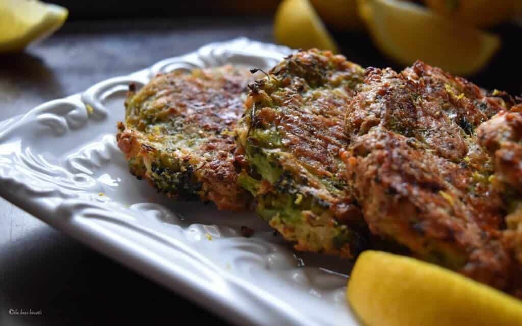 Broccoli fritters on a white serving dish.