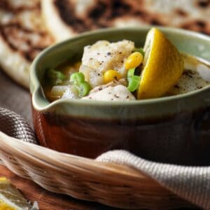 A bowl of vegetable fish chowder.