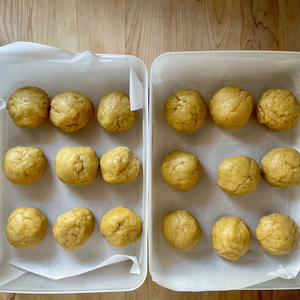 Balls of cookie dough in airtight containers.