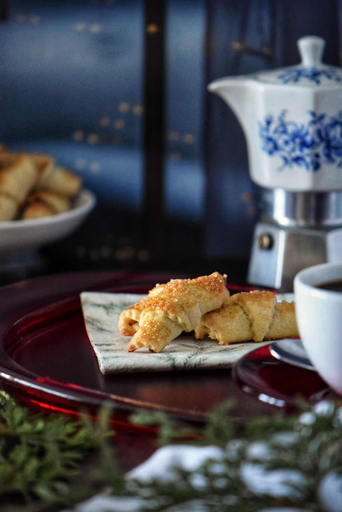 Chocolate croissant cookies on a red platter.