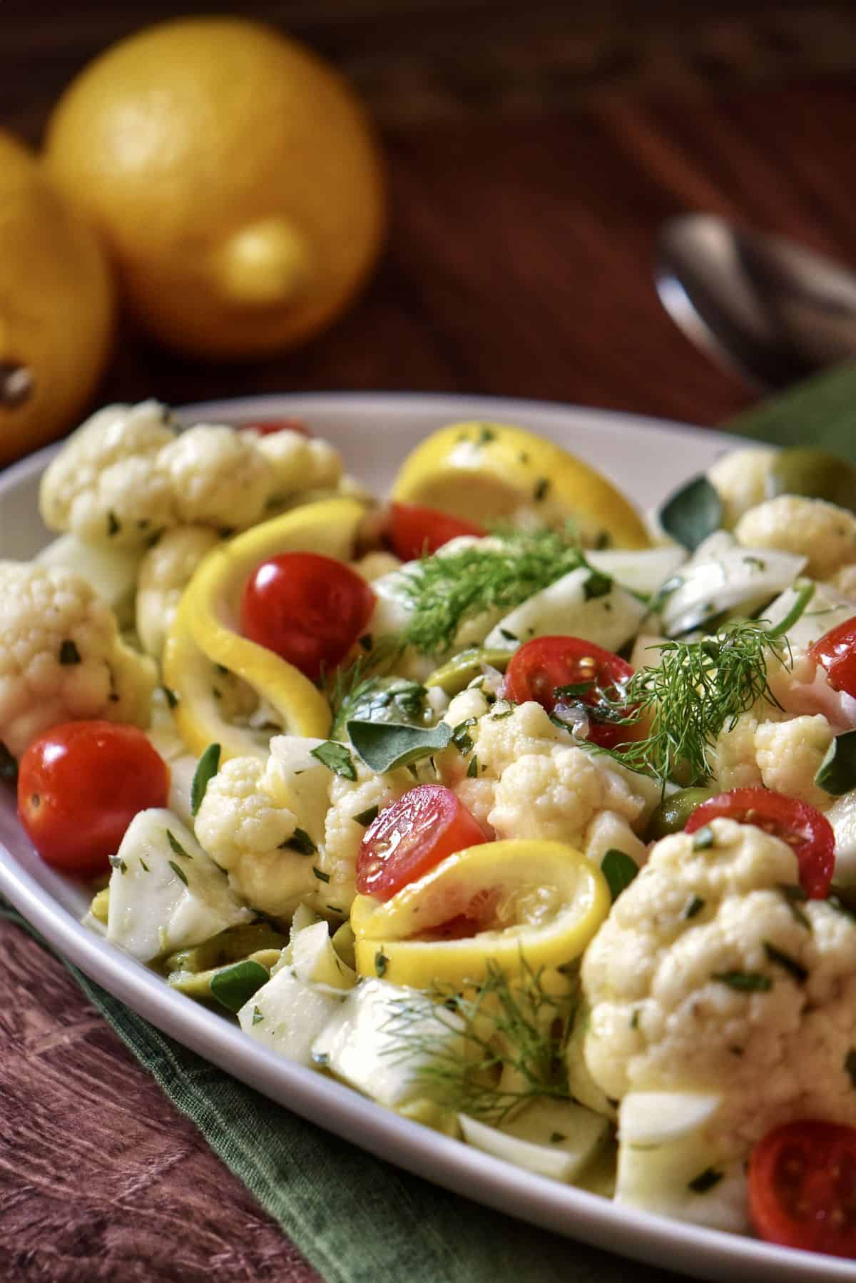 A colorful and unique salad recipe with cauliflower, fennel and cherry tomatoes.