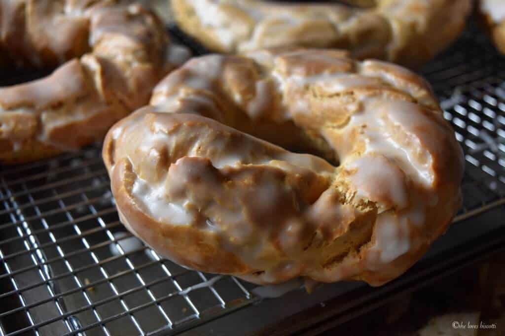 Glazed Easter Taralli Cookies resting on a cooling rack.