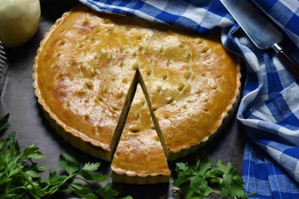 Italian pizza rustica with a slice cut.