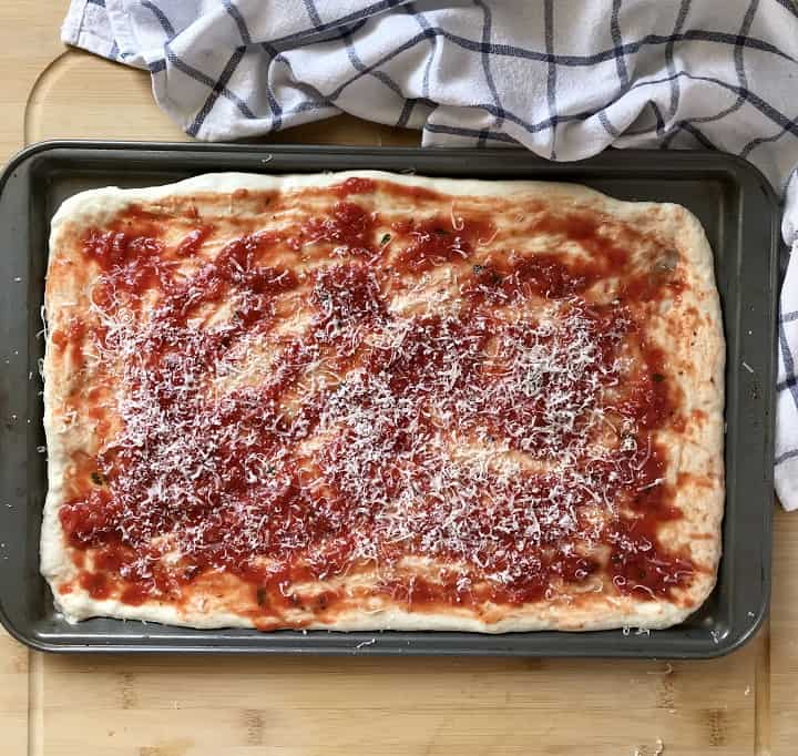 Homemade pizza is ready to be baked in the oven.