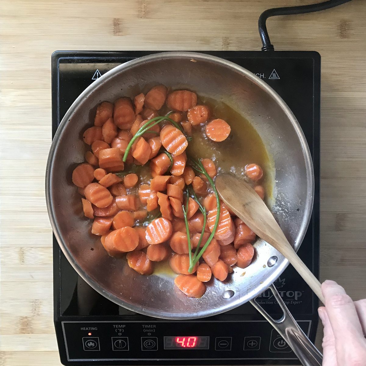 Sliced carrots simmering in vegetable broth.