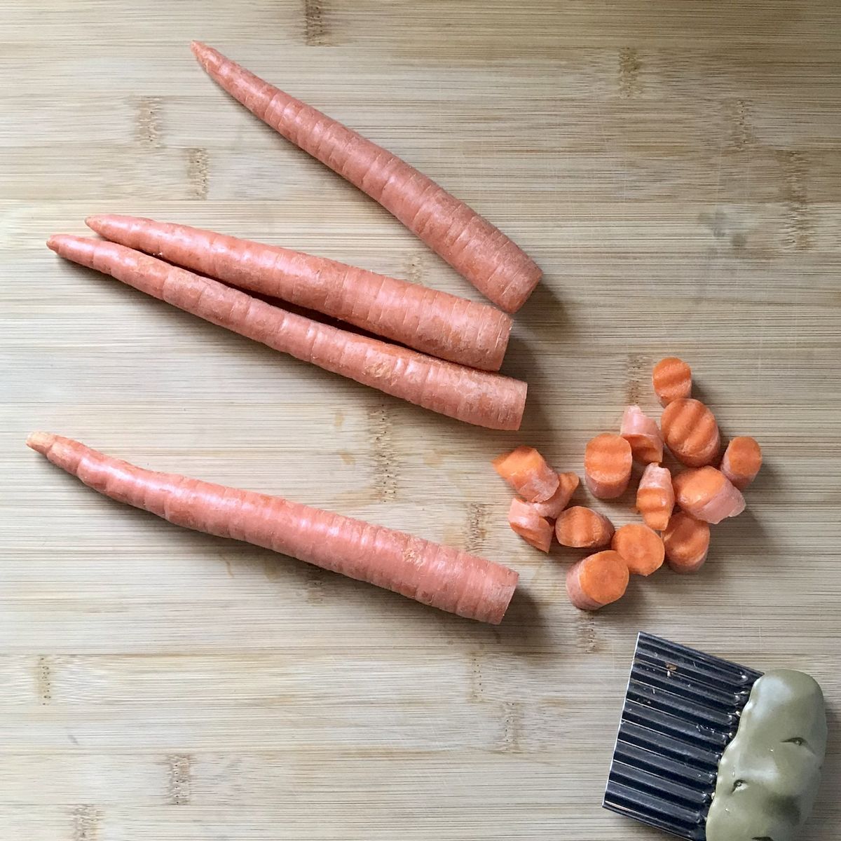 Crinkle cut carrots on a wooden board.